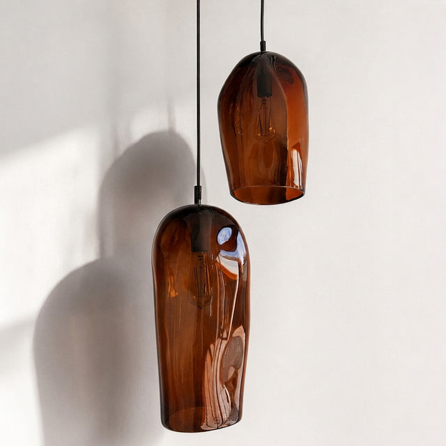 Marea I handblown amber glass pendant lights by Llewelyn Ash suspended together in a contemporary interior.