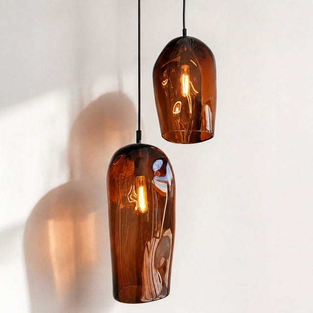 Marea I handblown amber glass pendant lights by Llewelyn Ash suspended together in a contemporary interior.