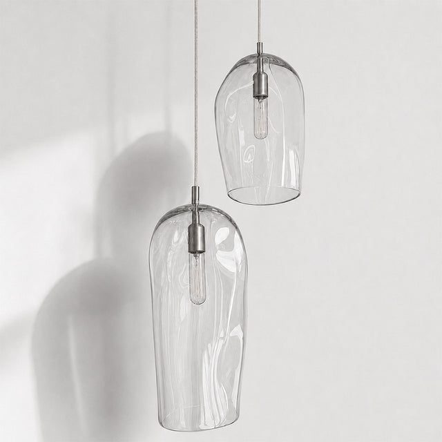 Marea I handblown amber glass pendant lights by Llewelyn Ash suspended together in a contemporary interior.