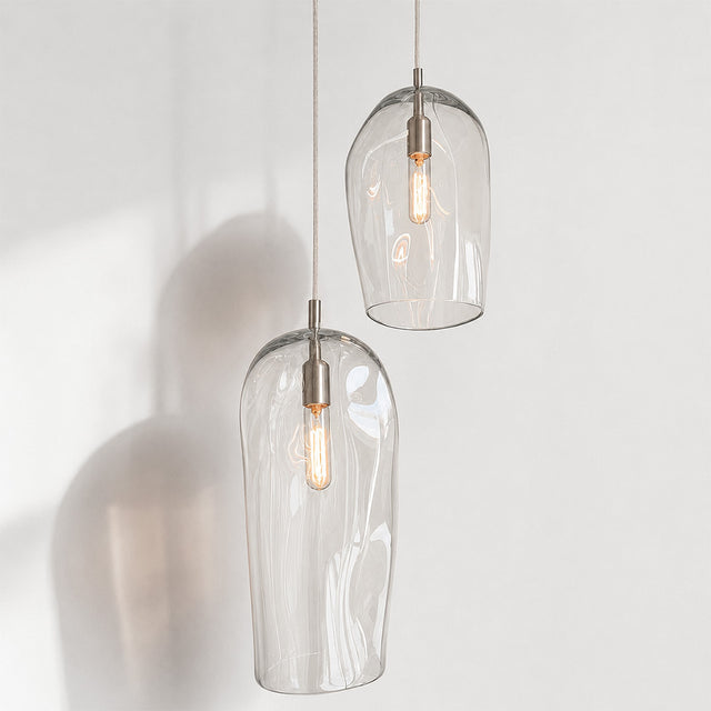 Marea I handblown amber glass pendant lights by Llewelyn Ash suspended together in a contemporary interior.