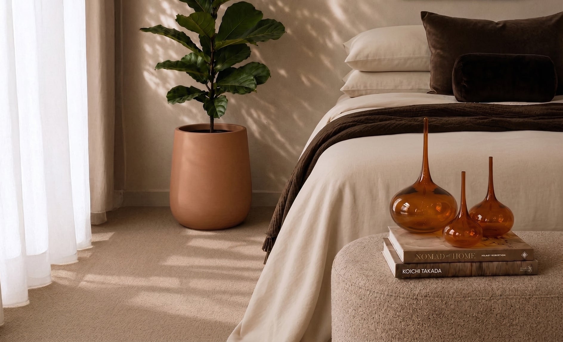 Australian made handblown amber glass decorative objects styled in a warm contemporary bedroom interior.