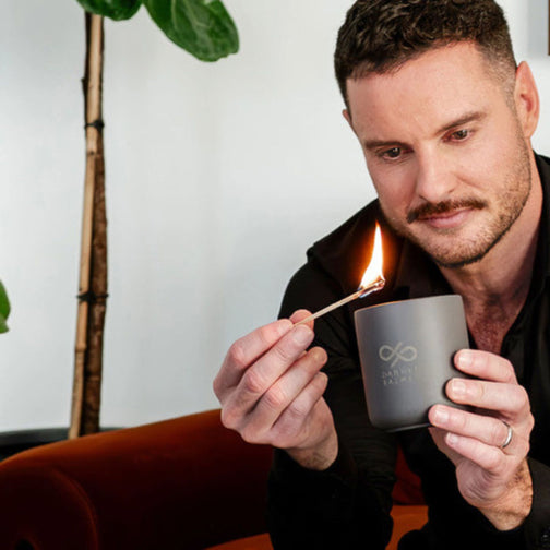 Darren Palmer lighting the Skinny Dip scented candle designed for Contemporary Co