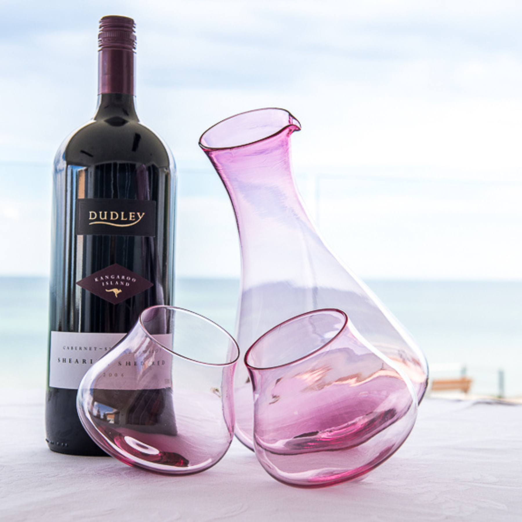 Emma Klau pink handblown Kinetic Wine Decanter with matching wine glasses, handcrafted in South Australia from art glass. Australian designer glassware for wine lovers and collectors.