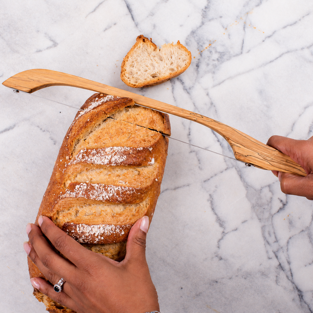 HASA Tasmania Fiddle Bow Bread Knife slicing sourdough bread, handmade in Australia