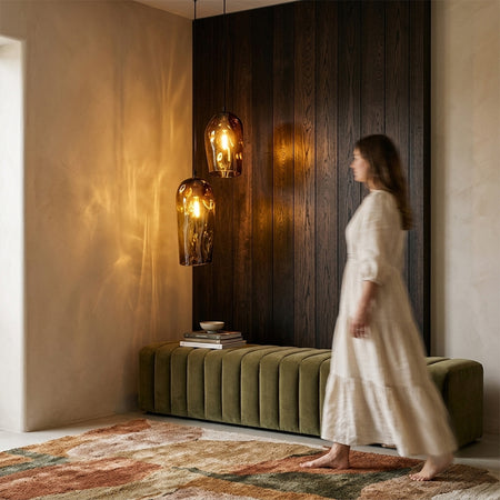 Two Marea Amber Australian made handblown glass pendant lights by Llewelyn Ash illuminated in a contemporary interior.