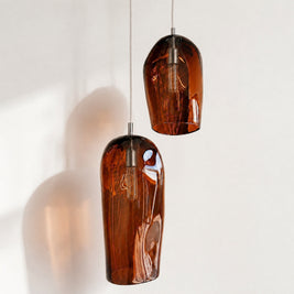 Marea I and Marea II Amber Australian made handblown glass pendant lights with stainless steel fittings, shown unlit.