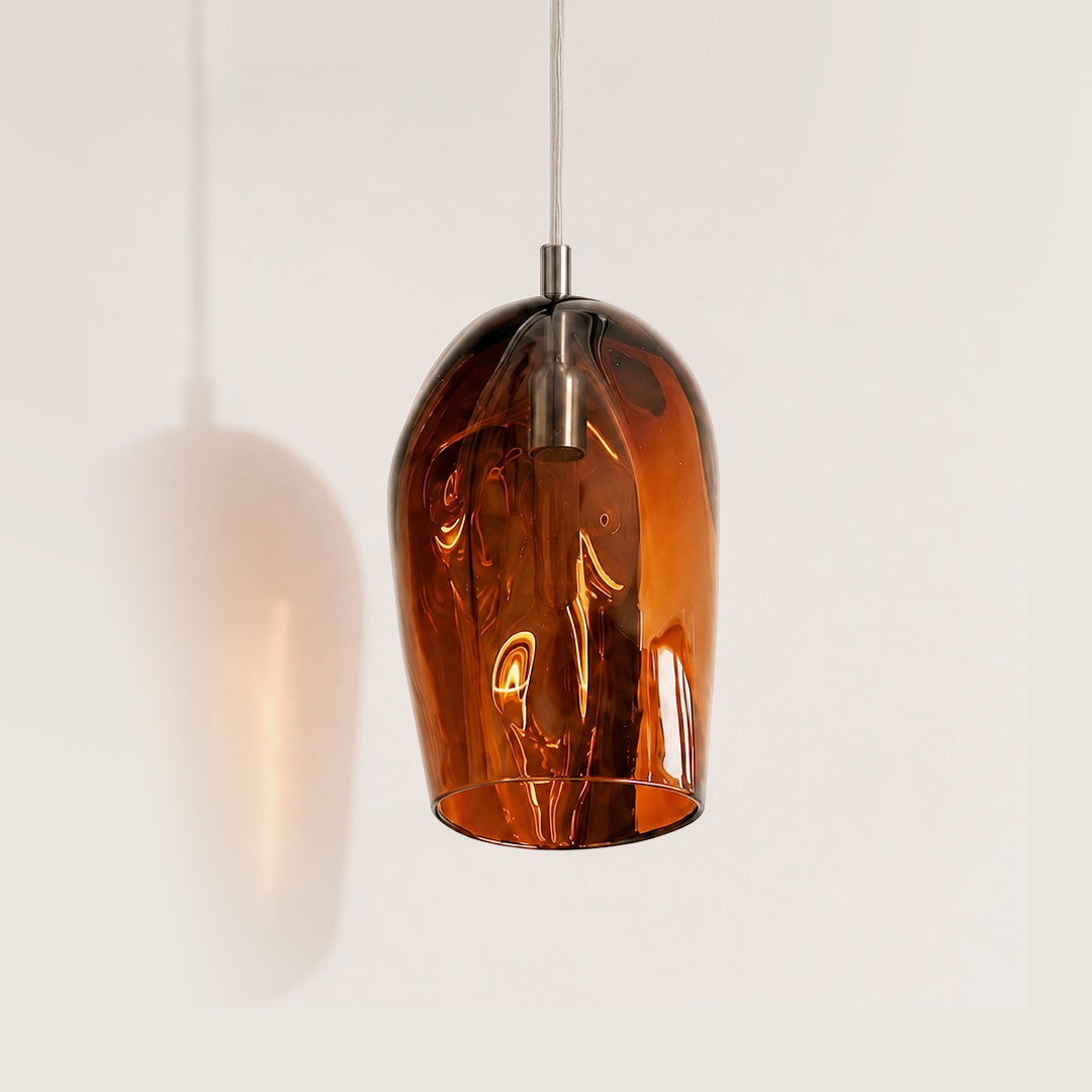 Marea I Amber Australian made handblown glass pendant light with stainless steel fitting, shown unlit.
