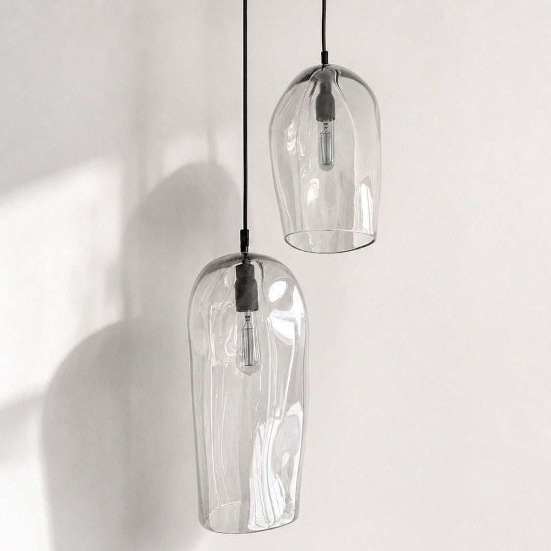 Marea I and Marea II Clear Australian made handblown glass pendant lights with black fittings, shown unlit.
