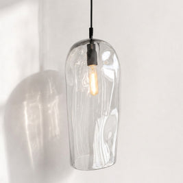 Marea II Clear Australian made handblown glass pendant light with black fitting, shown illuminated.