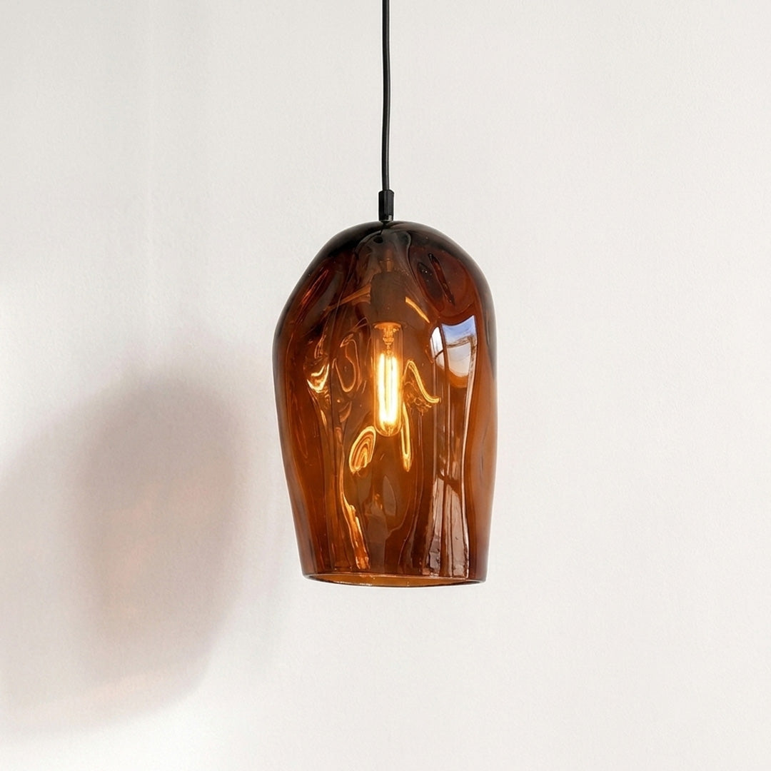 Marea I Amber Australian made handblown glass pendant light by Llewelyn Ash with black fitting, illuminated.