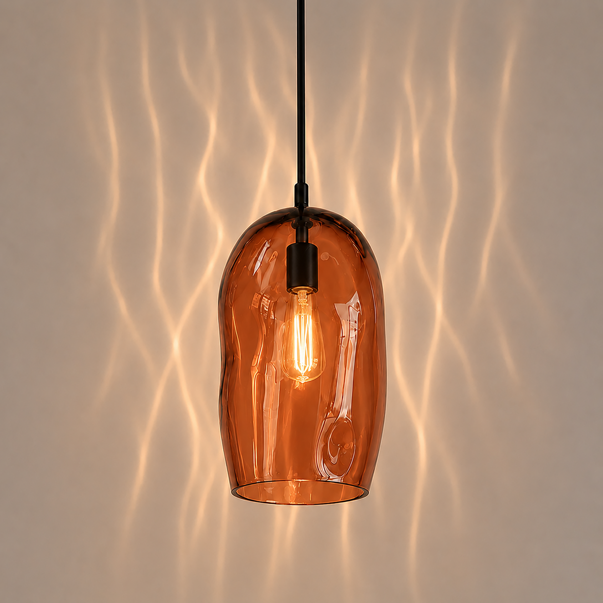 Marea I amber glass pendant light creating warm ambient lighting in a contemporary interior.