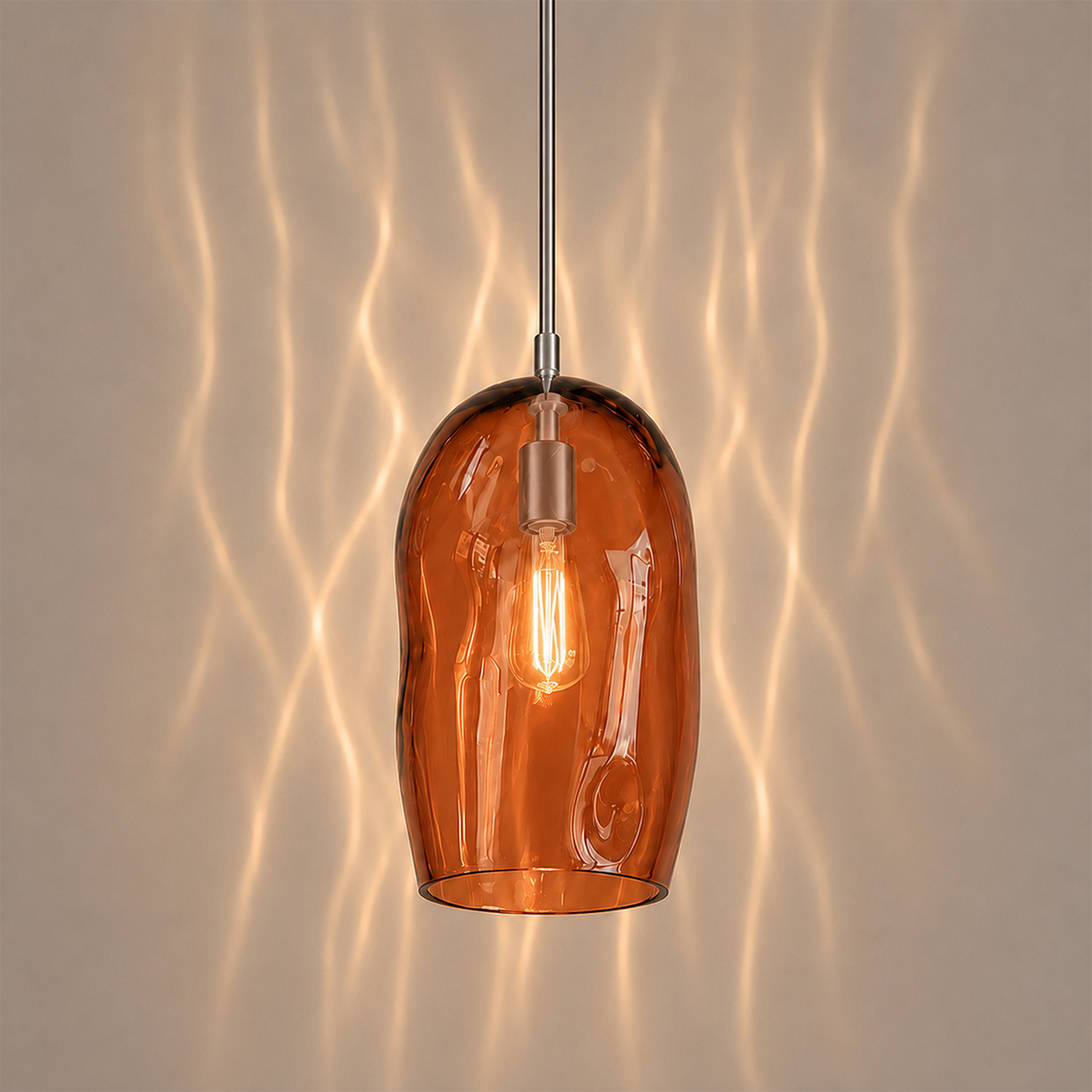 Marea I amber glass pendant light creating warm ambient lighting in a contemporary interior.