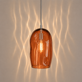 Marea I amber glass pendant light creating warm ambient lighting in a contemporary interior.