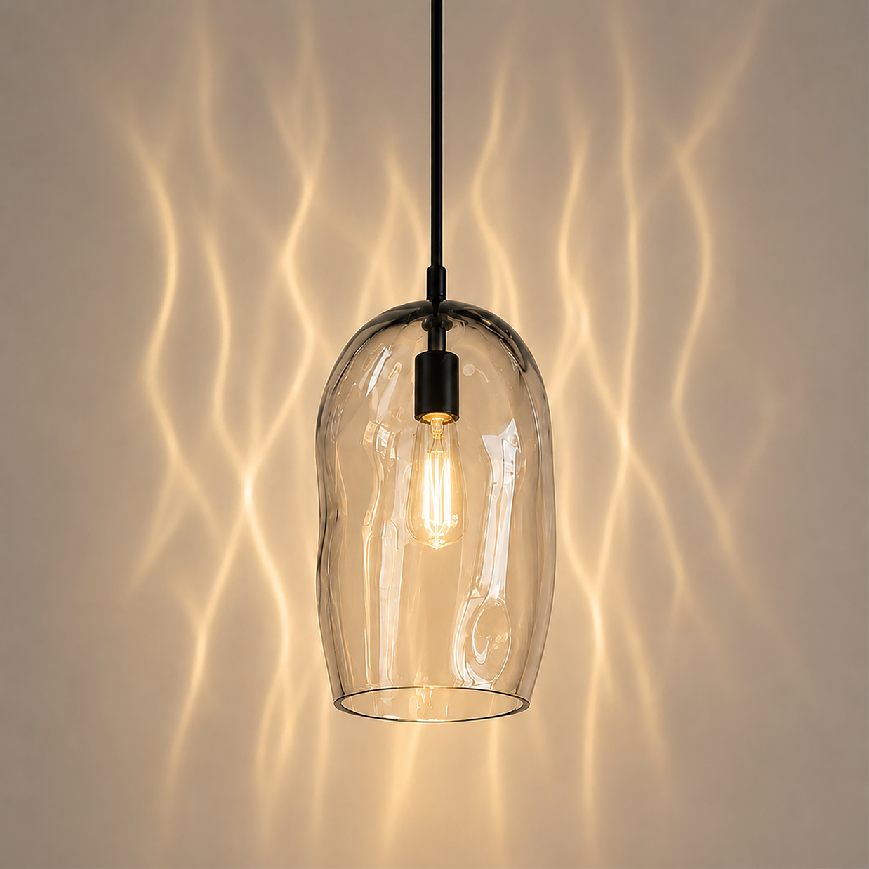 Marea I handblown clear glass pendant light by Llewelyn Ash with matte black hardware.