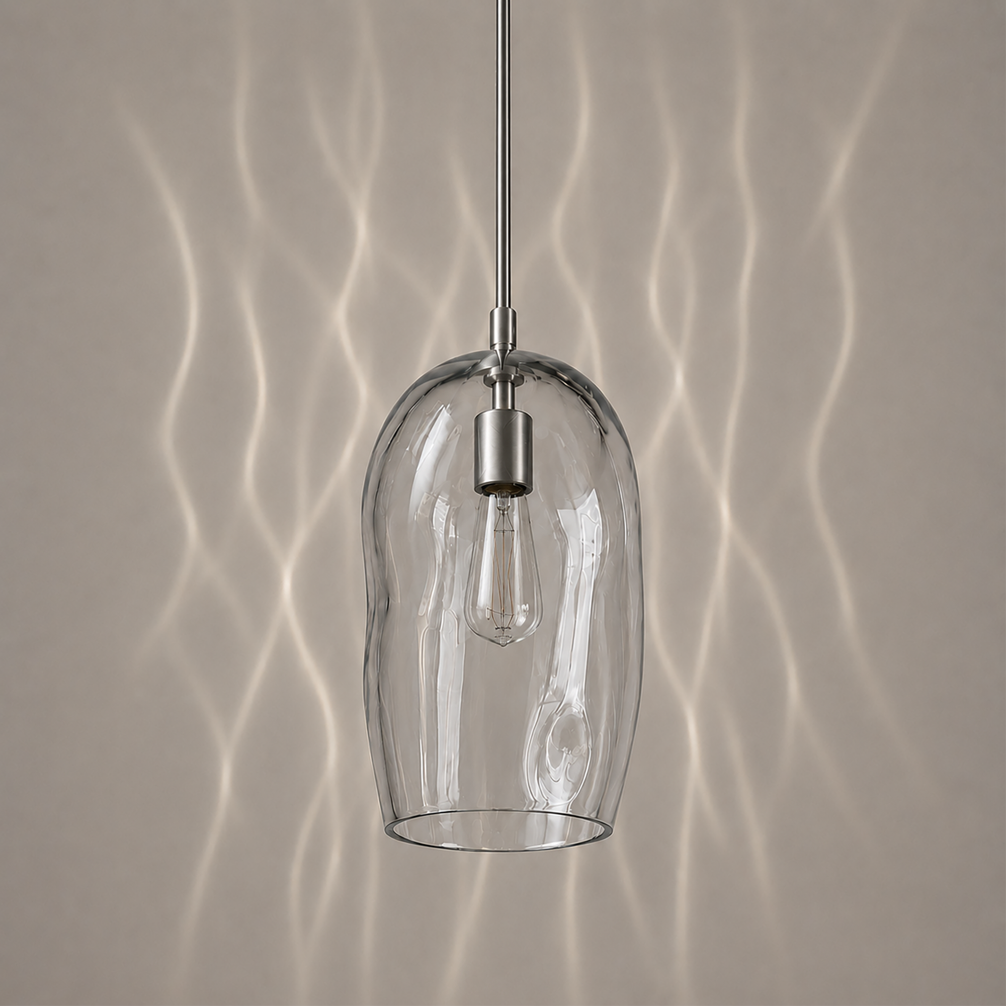 Marea I amber handblown glass pendant light switched off showing the natural glass colour.