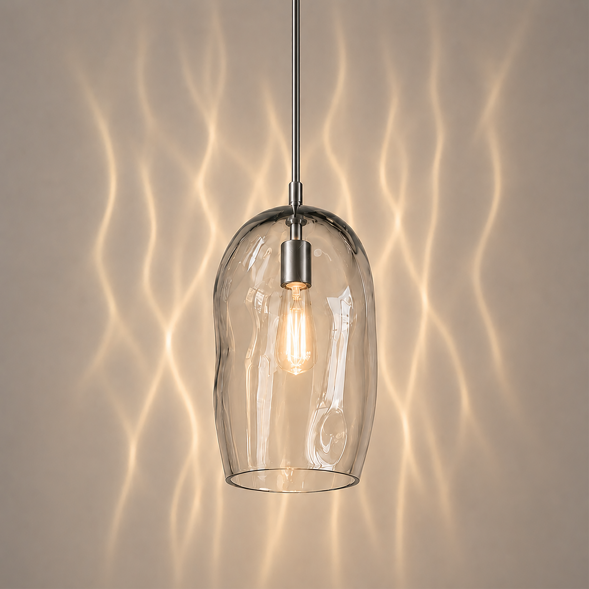 Marea I amber handblown glass pendant light switched on showing the natural glass colour.