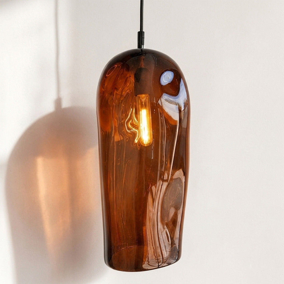 Marea II Amber Australian made handblown glass pendant light by Llewelyn Ash with black fitting, illuminated.