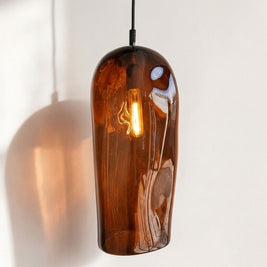Marea II Amber Australian made handblown glass pendant light by Llewelyn Ash with black fitting, illuminated.