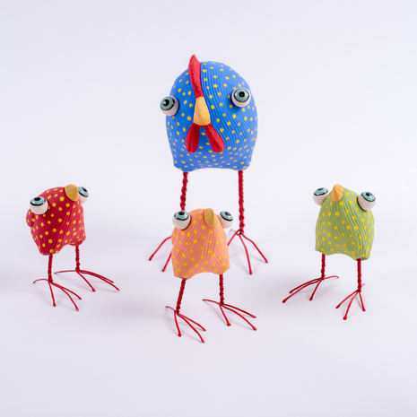 Colourful handmade ceramic mother hen and three chickens by Australian artist Elodie Barker. Whimsical sculptural bird artworks in blue, pink, red and green with spotted details and red wire legs, available at Contemporary Co.