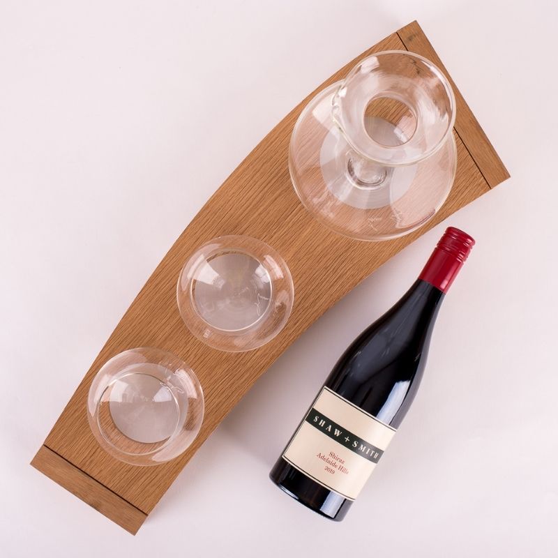 Emma Klau Kinetic wooden wine rack handcrafted from Western Australian oak, styled with handblown wine glasses, a glass decanter and wine bottle.